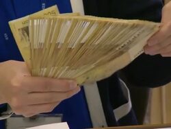Bank clerk counting a fifty thousand won note Stock Footage