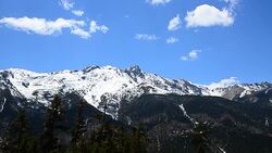 Snow Mountain Range Landscape with Blue Sky Backgrounds Stock Footage