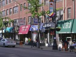 WS Street lined with shops day Stock Footage