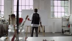Artist starts painting on canvas Stock Footage