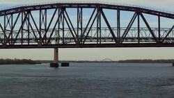Aerial passing under bridges on Delaware River on spring day Stock Footage