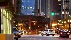 A sign spelling TRUMP looms over Wabash Avenue at night in Chicago. Stock Footage