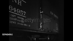 1936: DRAMATIZATION: Poor boys gathered at 'Alley Club' sharing cigarette. NIGHT: Young teenagers stealing bundles from New Haven Line railroad car, running from police, younger boy into darkness, locomotive moving. Juvenile deliquency, delinquent. Instructional Video