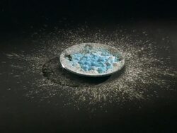 Hydrating anhydrous copper (II) sulphate (white) by dripping water. Stock Footage