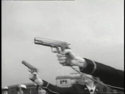 Uniformed members of the WAVES shoot guns at targets. News Clip