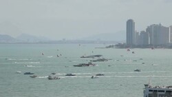 People parascending on parachute in blue sky in Pattaya, Thailand Stock Footage