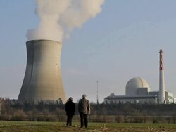 WS Couple in foregrand looks onward towards nuclear reactor / Schonau, Germany Stock Footage