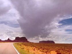 car POV TS desert road through Monument Valley and sandstone buttes / Kayenta, Arizona, USA Stock Footage