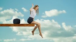 Woman sitting on edge of plank relaxing Stock Footage