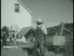 1938: ULSTER COUNTY COOPERATIVE: XWS Farm w/ mountain BG. VS Men working, hoeing crop, male leading cattle, Father Divine leaving farm in custom Duesenberg Model J w/ woman walking next to car. Men working in field. MS Plant in field. Instructional Video