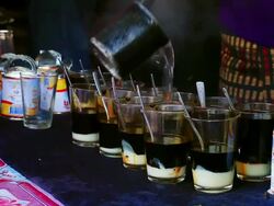 MS Shot of several glasses lined up with condensed milk and hot water for making coffer / Luang Prabang, Laos Stock Footage