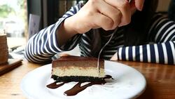 Young woman Eating Chocolate cheese Cake Stock Footage