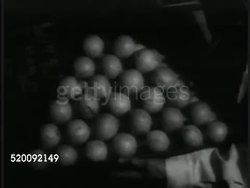 1935: MOSCOW, USSR, SOVIET UNION: Pastry display. Man pushing crate of lemons. Male trying on shoes. Automatic slicer slicing meat, butcher wrapping meat. CU Cash register ringing up sale. Consumerism, Russia, Communism, propaganda. Instructional Video