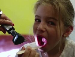 CU Shot of doctor looking into young girl's mouth / Ubud, Bali, Indonesia Stock Footage