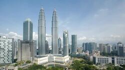 Clouds cast shadows as they drift over the Petronas Twin Towers in Kuala Lumpur's City Center. Stock Footage