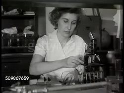 1948: HOSPITAL LABORATORY:  Laboratory on door, male walking through door. VS Medical technicians working in lab, placing drops on microscope slide (blood group), using microscope & hand counter (red blood cell count), CU hand counter Instructional Video