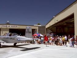 WS PAN Crowd of spectators at memorial day air show celebration exhibiting vintage world war two fighter planes parked outside their hangars at air museum / Palm Springs, California , United states Stock Footage