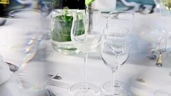 pouring white wine at fine dining table set up behind crystal curtain Stock Footage