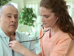 Healthcare Professional Listening to Heart of Man Stock Footage