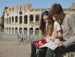 Tourists with guide and map in front of the Coliseum Stock Footage