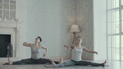 Two women doing yoga meditation and stretching exercises Stock Footage