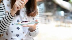 HD:Young woman eating blueberry cheese pie cake Stock Footage