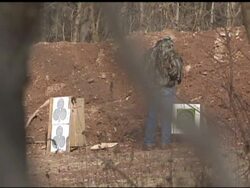 Gun enthusiasts on range firing at targets News Clip