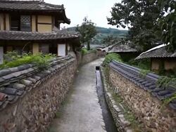 MS POV PAN Shot of Roof tile with Stone wall road at Changpyeong Slowcity / Damnyang, Jeollanamdo, South Korea Stock Footage