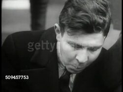 1933: U.S. CIVILIAN CONSERVATION CORPS: EXT VS Homeless eating on street. WS CCC Recruits arriving at camp. INT MS Recruits getting physical examination. EXT WS Lining up for drill (frame skip). Great Depression. New Deal Instructional Video