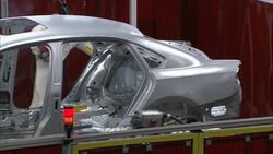 Robotic arms assemble auto parts in a factory. Stock Footage