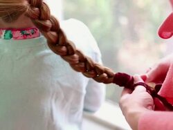 MS Mother braiding her daughter hair / St. Simon's Island, Georgia, United States Stock Footage