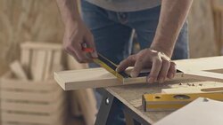 Carpenter marking wooden plank, using pencil and ruler Stock Footage