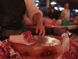 MS POV SLO MO Woman vendor chopping up bones meat market / Vientiane, Laos Stock Footage