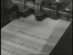 Newspapers run through a printing press. News Clip