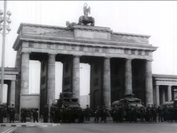 B/W 1961 crowd of soldiers standing in front of Brandenburg Gate / West Berlin / Cold War / doc. Stock Footage
