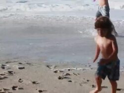 MS R/F PAN Man, boy and girl hold bounce water balloons on beach / Montezuma, Puntarenas, Costa Rica Stock Footage