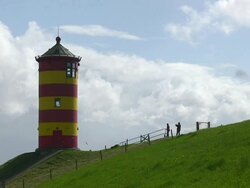 MS Family enjoing at Pilsum lighthouse near Krummhorn at North Sea (Eastern Friesland) / Lower Saxony Stock Footage