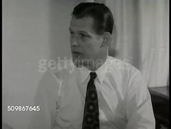 1948: DRAMATIZATION OF HOUSE CALL: Doctor in bedroom w/ patient 'Mrs. Conrad', telling husband tests confirm wife has gallstones, needs operation. Instructional Video