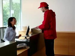 MS ZI Delivery man giving box to receptionist  / Brussels , Brabant, Belgium Stock Footage