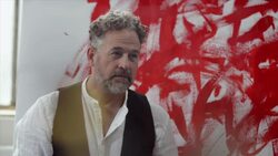 Artist painting with red color on canvas Stock Footage