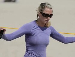ECU CU of female beach volleyball player stretching and using bands to warm up. Stock Footage