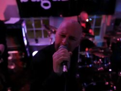 MS male singer with band singing into microphone on stage/Norwich/Norfolk/UK Stock Footage
