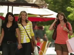 MS Three young women with shopping bags walking down street, listening to MP 3 player, Provo, Utah, USA Stock Footage