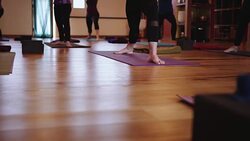 Low sliding shot of yoga class Stock Footage