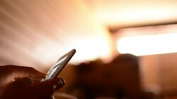 Woman using phone in bed Stock Footage