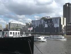 WS Two boats moving in Thames river in front of sea containers house hotel at Victoria Embankment / London, United Kingdom Stock Footage