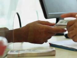 Man depositing money at bank counter, Delhi, India Stock Footage