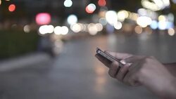 HD:Woman touching smartphone at night time Stock Footage