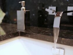 MS PAN Shot of flowing water in modern home bathroom sink / Lake Oswego, Oregon, United States Stock Footage