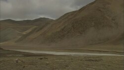 Dust blows across a mountainous Tibetan landscape. Stock Footage